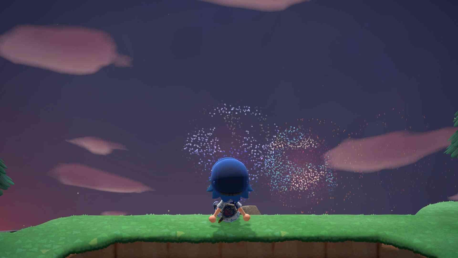 Animal Crossing New Horizons. The player character is sitting on a hill watching fireworks. There are two firework explosions in the sky, both Kirby characters.